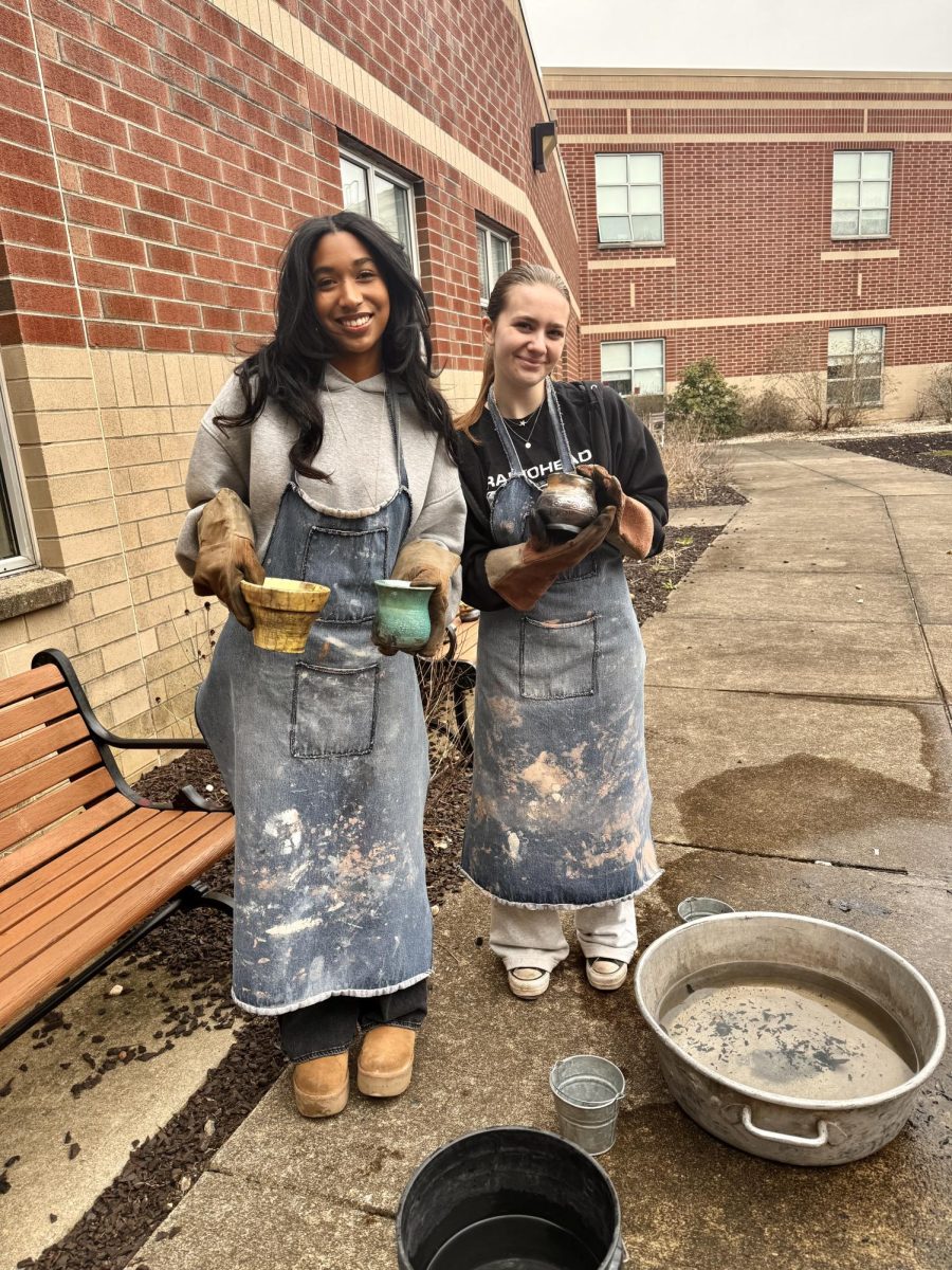 Parkland ceramics students, Dayna Josephs and Anna Lorah learning a new way of firing clay called Raku.