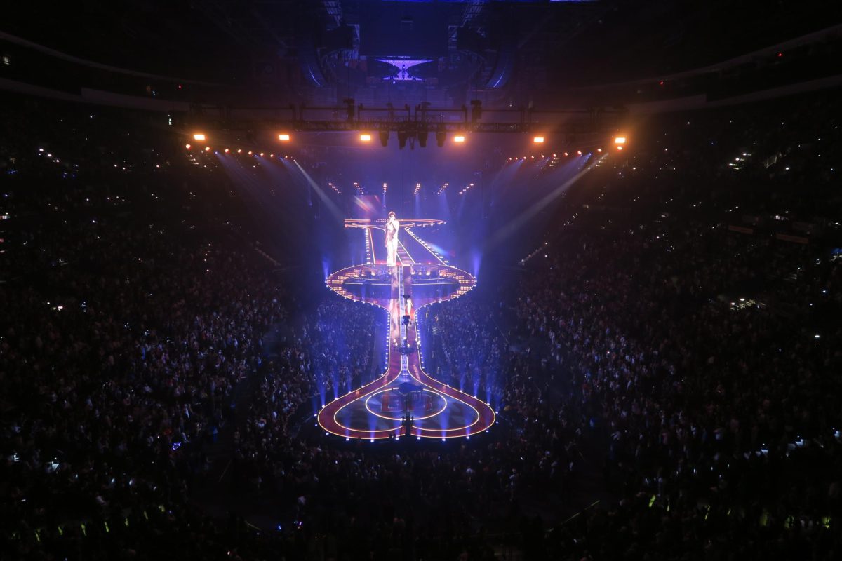 Performing Benson Bonne lights up the stadium with the stages colorful lights 
