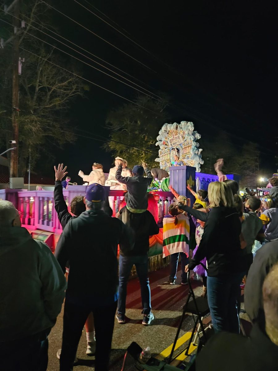One of the floats at the Mardi Gras parade at night . 