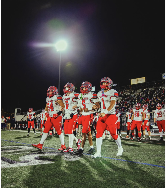 Parkland Football captains walk out to the coin toss in the 2025 District 11 Championship.